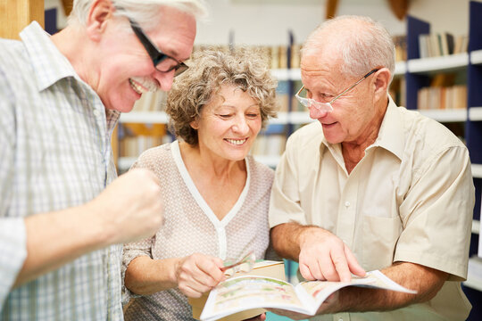 Seniors in the library with a book