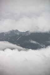 swiss mountains in the clouds, foggy weather in Switzerland