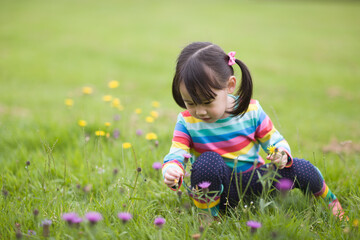 young girl playing in the summer forest park