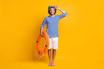 Full length photo of guy hold life buoy touch scuba goggles wear blue striped shirt shorts isolated...