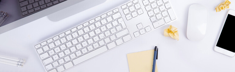 new modern keyboard with screen and computer mouse with smartphone and clumps of paper isolated on...