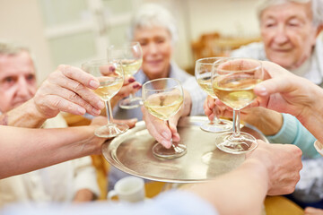 Seniors celebrate with a glass of white wine