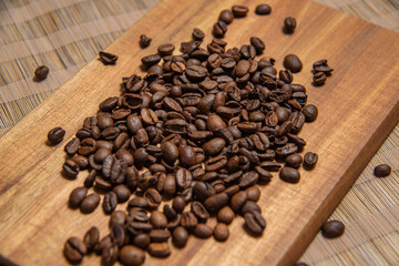 Fototapeta na wymiar roasted coffee beans and a cup of coffee