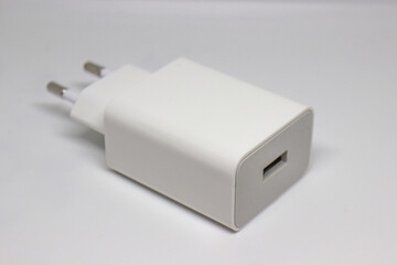 White mobile phone chargers on a white background