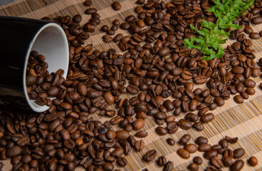 roasted coffee beans and a cup of coffee