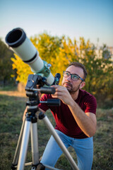 Amateur astronomer looking at the sky with a telescope.