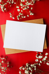 postcard for congratulations and invitations. envelope and white flowers on a red background