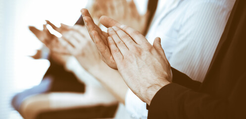 Business people clapping and applause at meeting or conference, close-up of hands. Group of unknown...