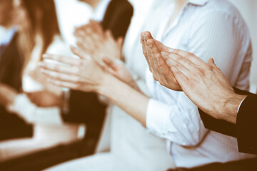 Business people clapping and applause at meeting or conference, close-up of hands. Group of unknown...