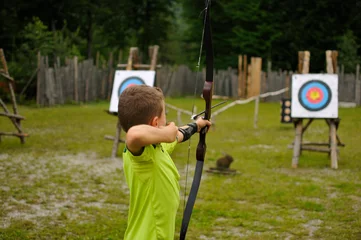 Tuinposter Boy at archery with bow and arrow © Mitch Shark