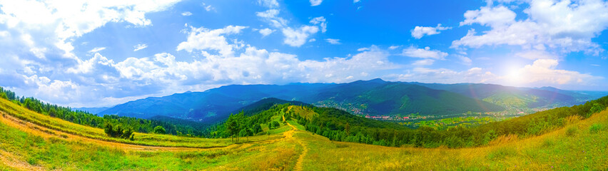 Fototapeta na wymiar Panorama view of mountains. Beautiful landscape. Sky with clouds. Amazing nature. Wanderlust concept.