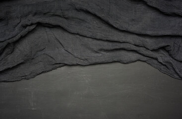 black kitchen textile towel folded on a black wooden table