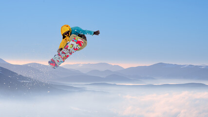 Snowboarder Jumping on Snowboard in the Mountains. Snowboarding and Winter Sports