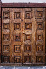 Brown wooden door with carved decorations
