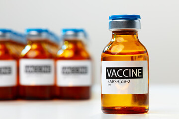 Sars-cov-2 vaccine vial bottles on white table