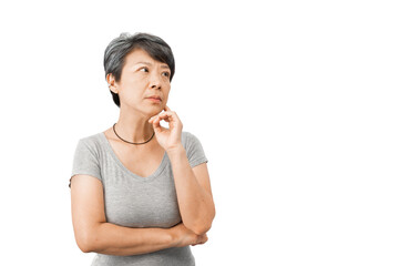 A middle-aged gray-haired Asian woman is wondering, confused, touching her face with her fingers,...