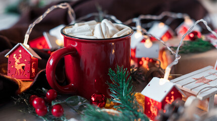 Winter hot drink, cacao with marshmallows and cinnamon or spicy hot chocolate in red cup. Merry Christmas. Festive vintage background