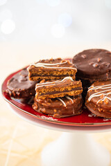 Chocolate biscuit sandwich in chocolate and nut glaze on christmas background