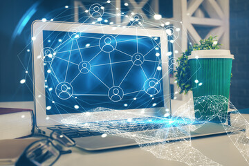 Computer on desktop with social network hologram. Multi exposure. Concept of international people connections.