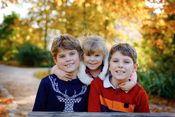 Portrait of three siblings children. Two kids brothers boys and little cute toddler sister girl...