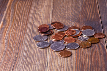 American coins and US dollars on a wooden table