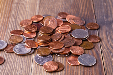 American coins and US dollars on a wooden table