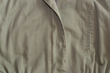 A fragment of a brown thick fabric jacket