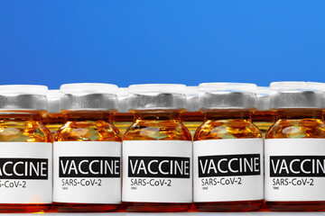 Sars-cov-2 vaccine vial bottles on white table