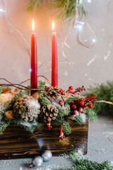 Decorative christmas composition with red candles and pine