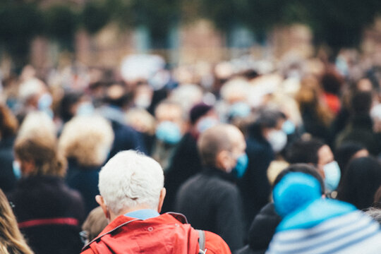 Rear View Of People Gathering At A Protest All Of Them Wearing Protective Masks Due To COVID-19 Coronavirus Epidemic Situation