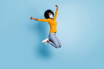 Fototapeta na wymiar Photo portrait full body of excited girl celebrating jumping up wear facial mask isolated on pastel blue colored background
