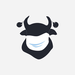 New Year. Black silhouette of a bull in a medical mask and with Christmas balls on its horns is a symbol of 2021.
