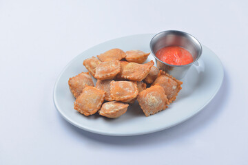 Fried dumplings on a plate with tomato dip sauce. Delicious idea for dinner.