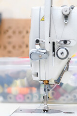 Needle presser foot with thread of industrial sewing machine for sew cloth copy space close-up.