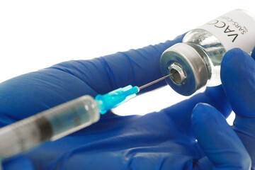 Doctor hands holding covid-19 vaccine preparing for vaccination of a patient