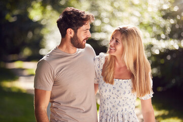 Loving Couple Walking Along Countryside Path In Summer Together