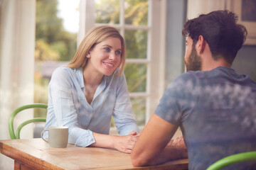 Couple Meeting For Date In Coffee Shop Viewed Through Window