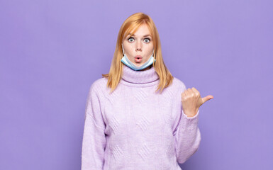 pretty woman  looking astonished in disbelief, pointing at object on the side and saying wow,...