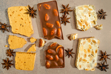 Popular nougat candy from Alicante traditionally consumed at Christmas in Spain called turron. Various pieces of sweet delicacy made from honey, almond, eggs, chocolate, marzipan-decorated with anise.