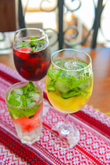 Glasses of red wine and white wine with watermelon pieces on the table. Delicious cold fruit drink served in glasses.