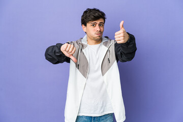 Naklejka premium Young cool man showing thumbs up and thumbs down, difficult choose concept