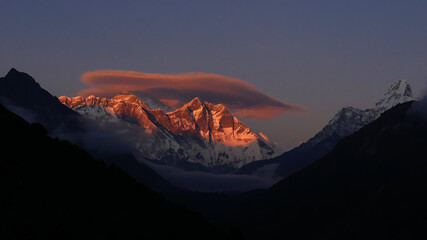 Spectacular panorama view of majestic Mount Everest, Nuptse, Lhotse and Ama Dablam mountains with red illuminated peaks at sunset from a viewpoint near Namche Bazar, Khumbu, Himalayas, Nepal.