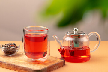 Glass teapot and cup with black tea