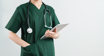 Doctor stands with stethoscope and digital tablet on the white background.