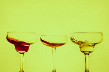 splash cocktails on neon background  