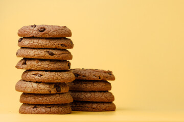 Fototapeta na wymiar Pile of chocolate chip cookies on yellow backgreound