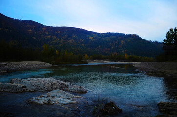 landscape with mountains, forest and a river in front. beautiful scenery