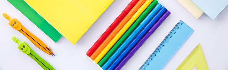 collection of bright colorful stationery on light background, close view . High quality photo