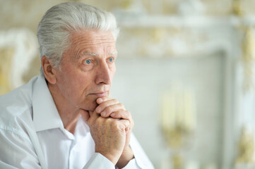 Close-up portrait of sad thinking senior man