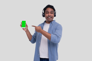Indian Man Listening to Music from Phone Pointing at It. Man Singing to the Music. Man Pointing at Phone Green Screen. Isolated